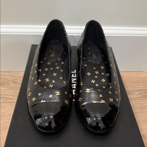 Brand new authentic CHANEL black leather flats with gold logos